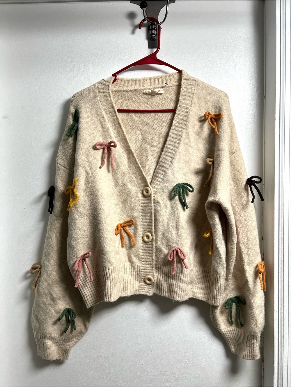 Entro Cream V-Neck Cardigan with Multicolor Bows